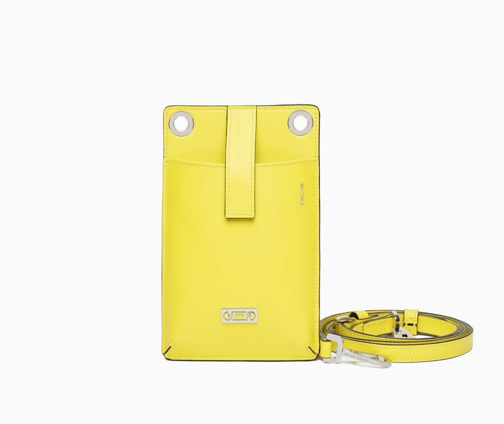 The Come Fly With Me! in Yellow Lime. Front view showing smooth Italian leather, compact crossbody silhouette with external phone pocket and sturdy brass hardware plated in palladium.