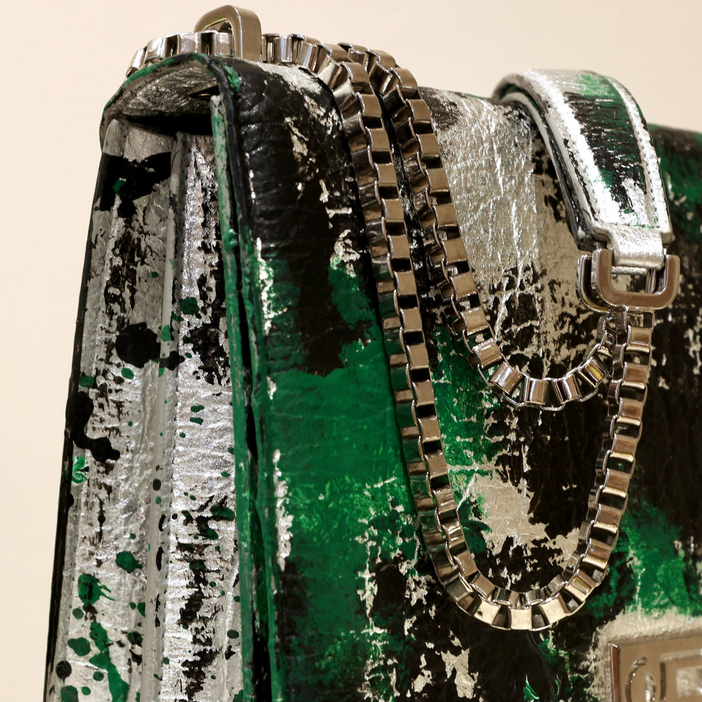 Close-up of The Cristiana “Piece of My Heart” highlighting hand-painted Piñatex, palladium-plated chain hardware, and tactile contemporary craftsmanship.