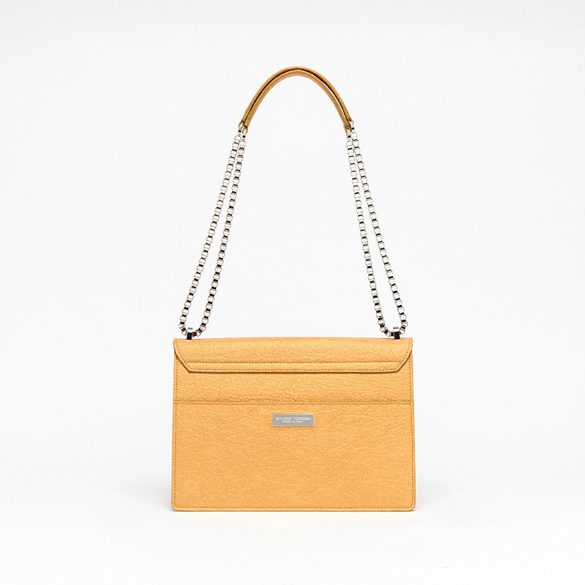 The Cristiana Vegan Shoulder Bag by Studio Tondini. Back view of the antique gold version, showcasing clean architectural lines, a rear pocket, and the discreet branded plate.