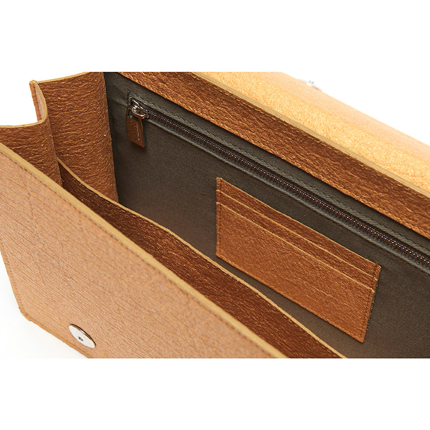 The Cristiana Vegan Shoulder Bag by Studio Tondini. Interior view of the antique gold version, revealing structured compartments lined in cotton and Piñatex® - refined, functional, and consciously crafted.