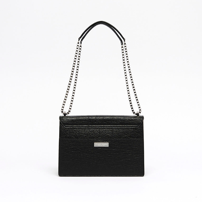 The Cristiana Vegan Shoulder Bag by Studio Tondini. Back view of the black version, showcasing clean architectural lines, a rear pocket, and the discreet branded plate.