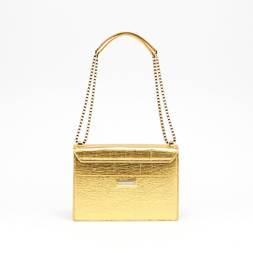 The Cristiana Vegan Shoulder Bag by Studio Tondini. Back view of the gold version, showcasing clean architectural lines, a rear pocket, and the discreet branded plate.