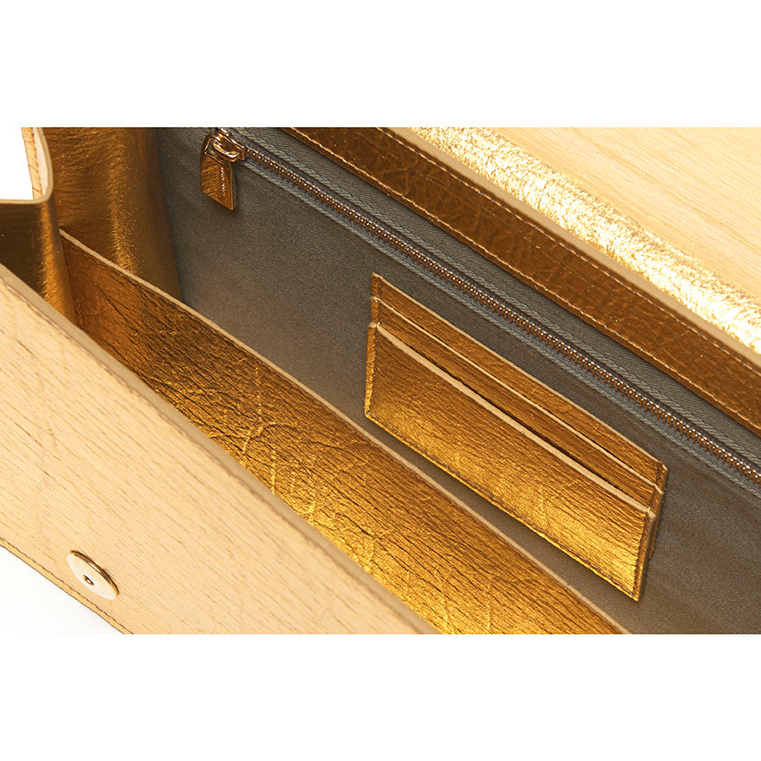 The Cristiana Vegan Shoulder Bag by Studio Tondini. Interior view of the gold version, revealing structured compartments lined in cotton and Piñatex® - refined, functional, and consciously crafted.