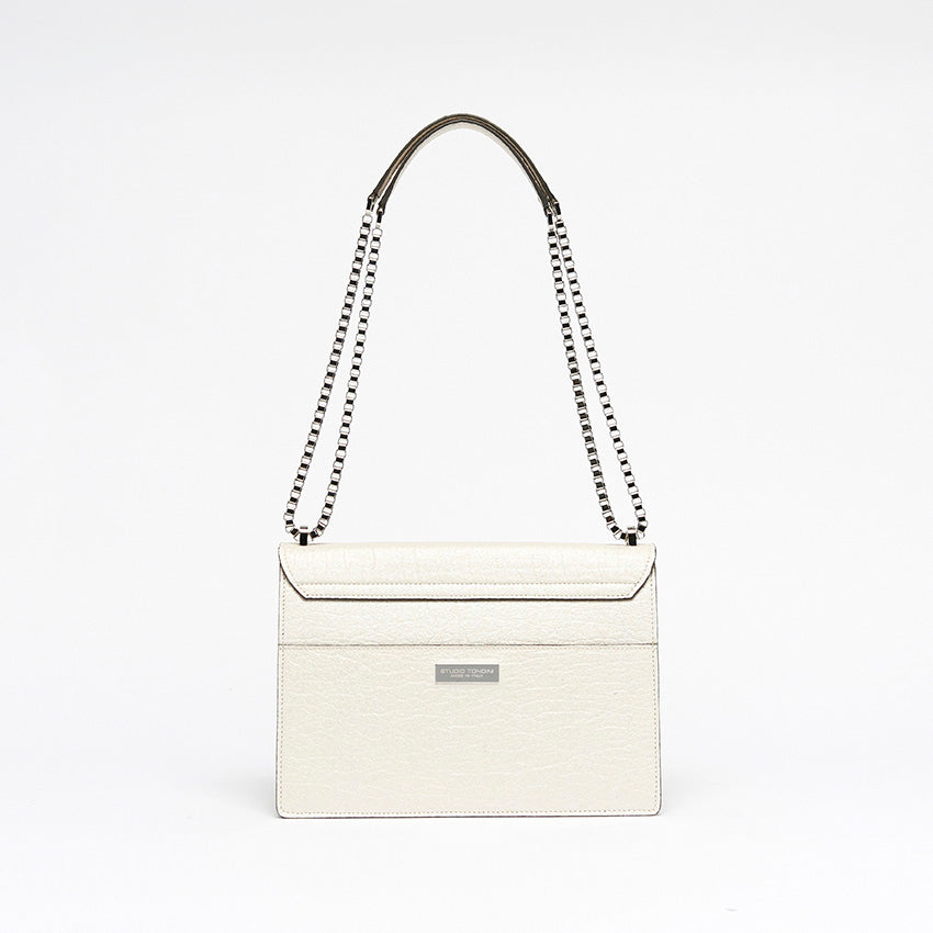 The Cristiana Vegan Shoulder Bag by Studio Tondini. Back view of the pearled white version, showcasing clean architectural lines, a rear pocket, and the discreet branded plate.