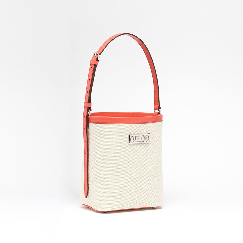 Three-quarter view of The Francesca canvas bucket bag highlighting soft structure, leather detailing, and understated contemporary elegance crafted in Italy.